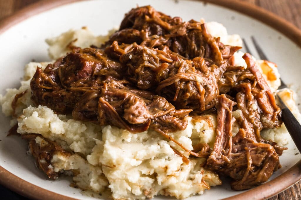 plate of mississippi pot roast without pepperoncini over mashed potatoes