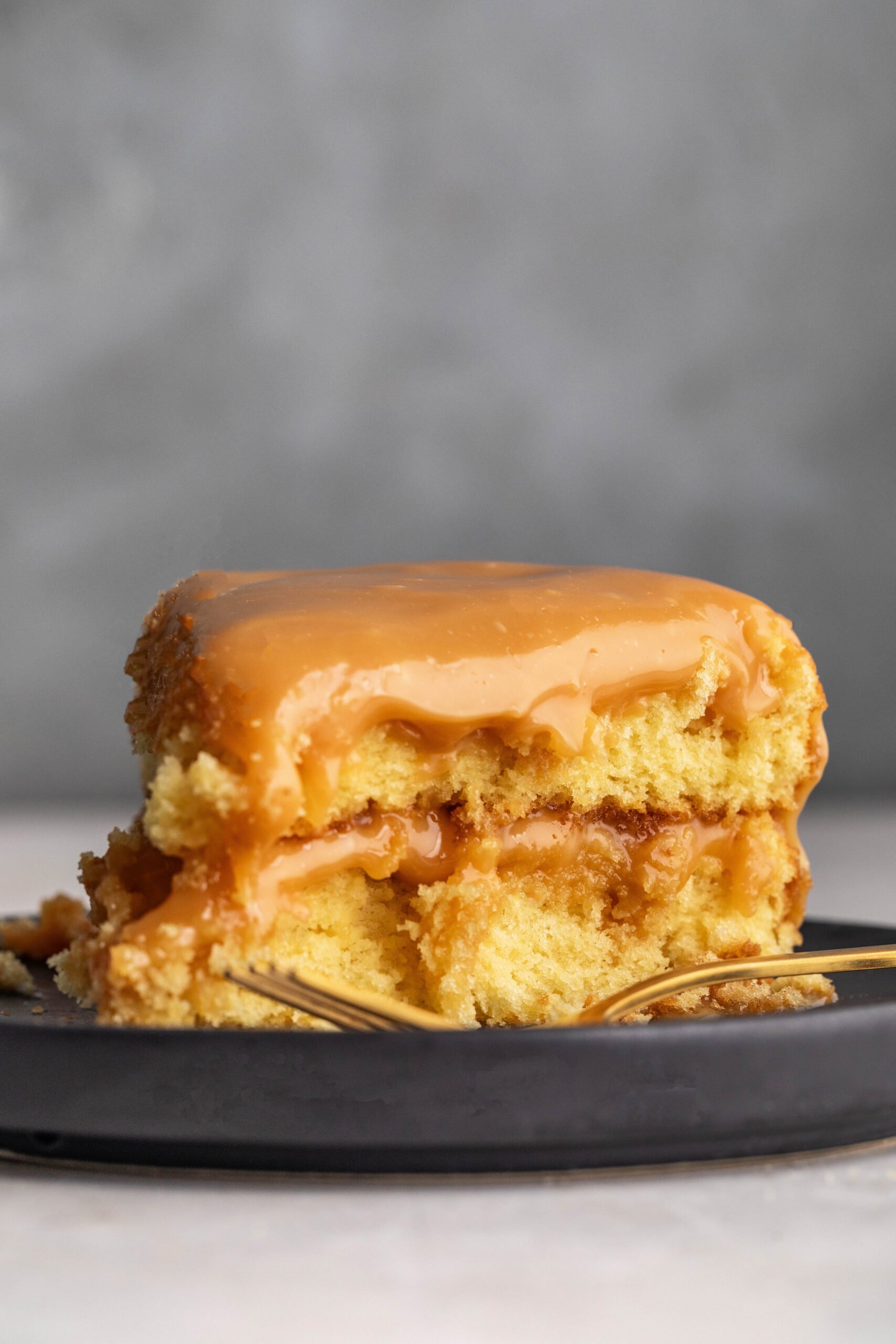 a slice of 2 layer caramel cake on a plate