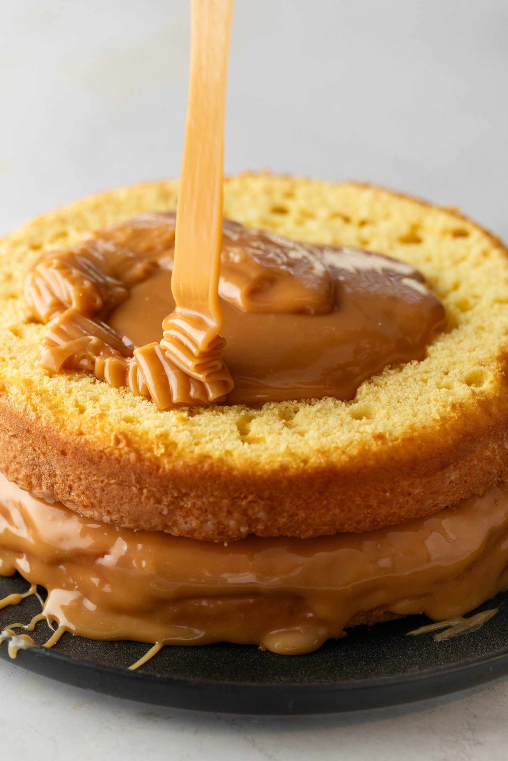 caramel pouring over caramel cake