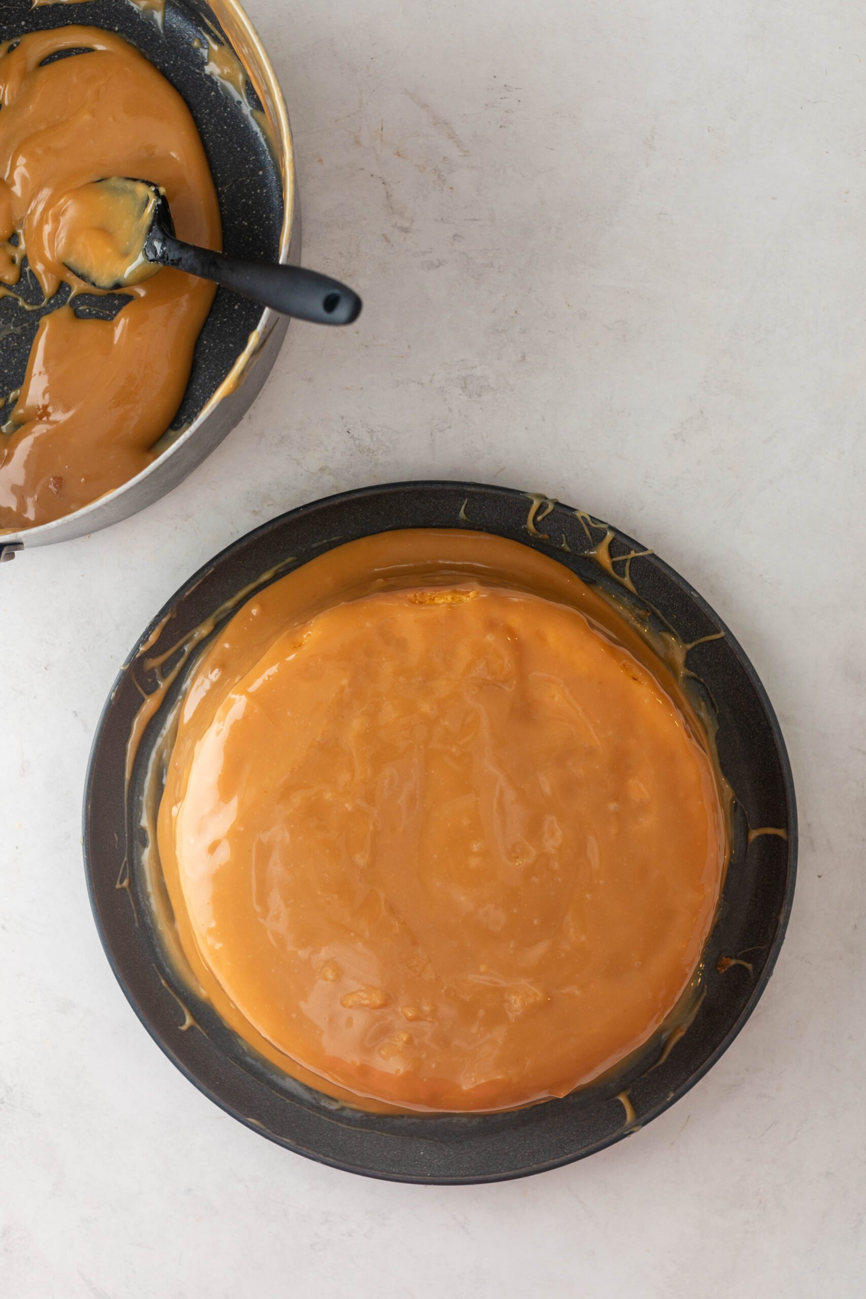 homemade caramel cake with a saucepan of caramel