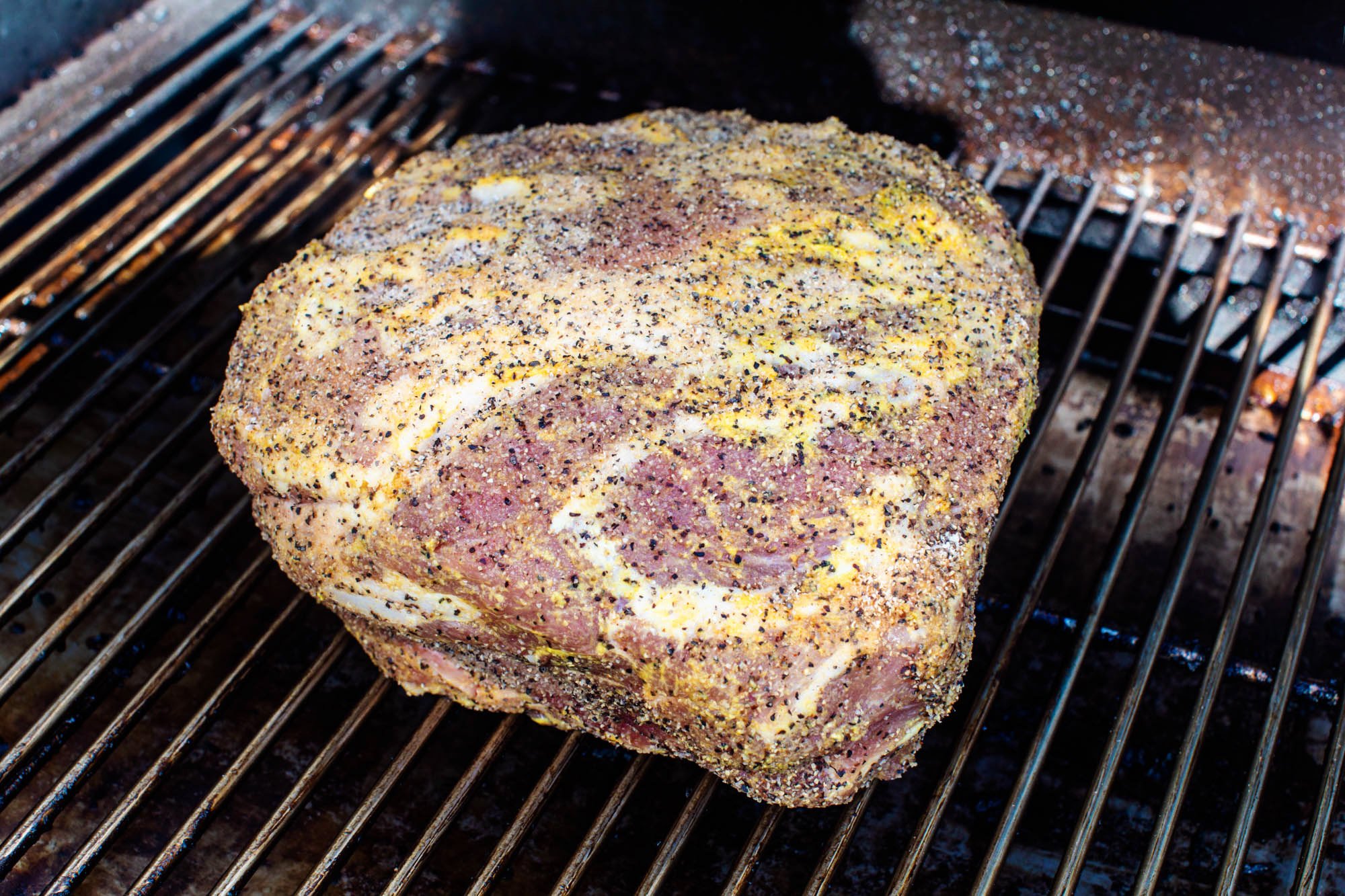 A boston butt on a smoker grill.