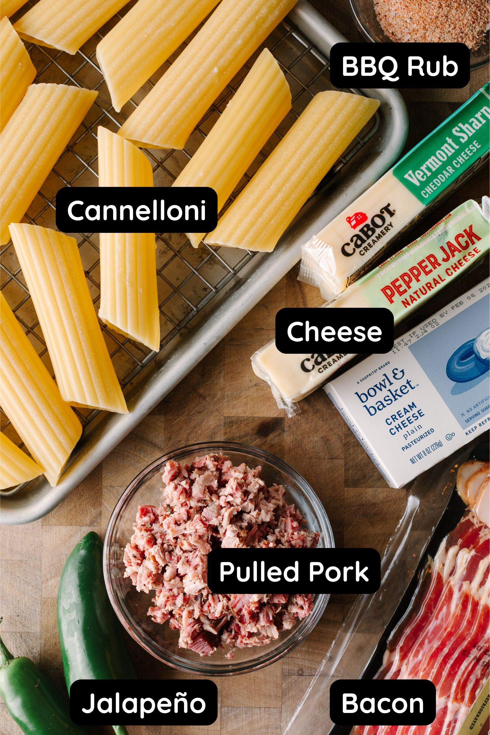 Ingredients for smoked shotgun shells: Cannelloni, BBQ rub, cheddar cheese, pepperjack cheese, cream cheese, pulled pork, bacon, and jalapeno. 