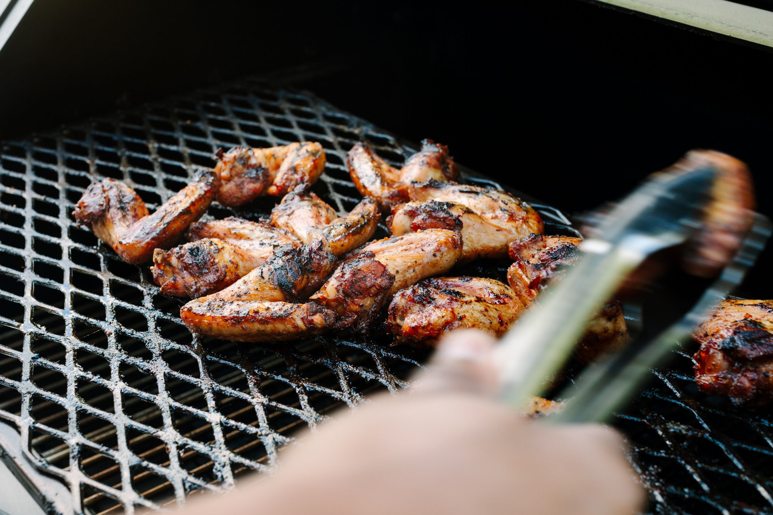 Asian chicken wings on a smoker.