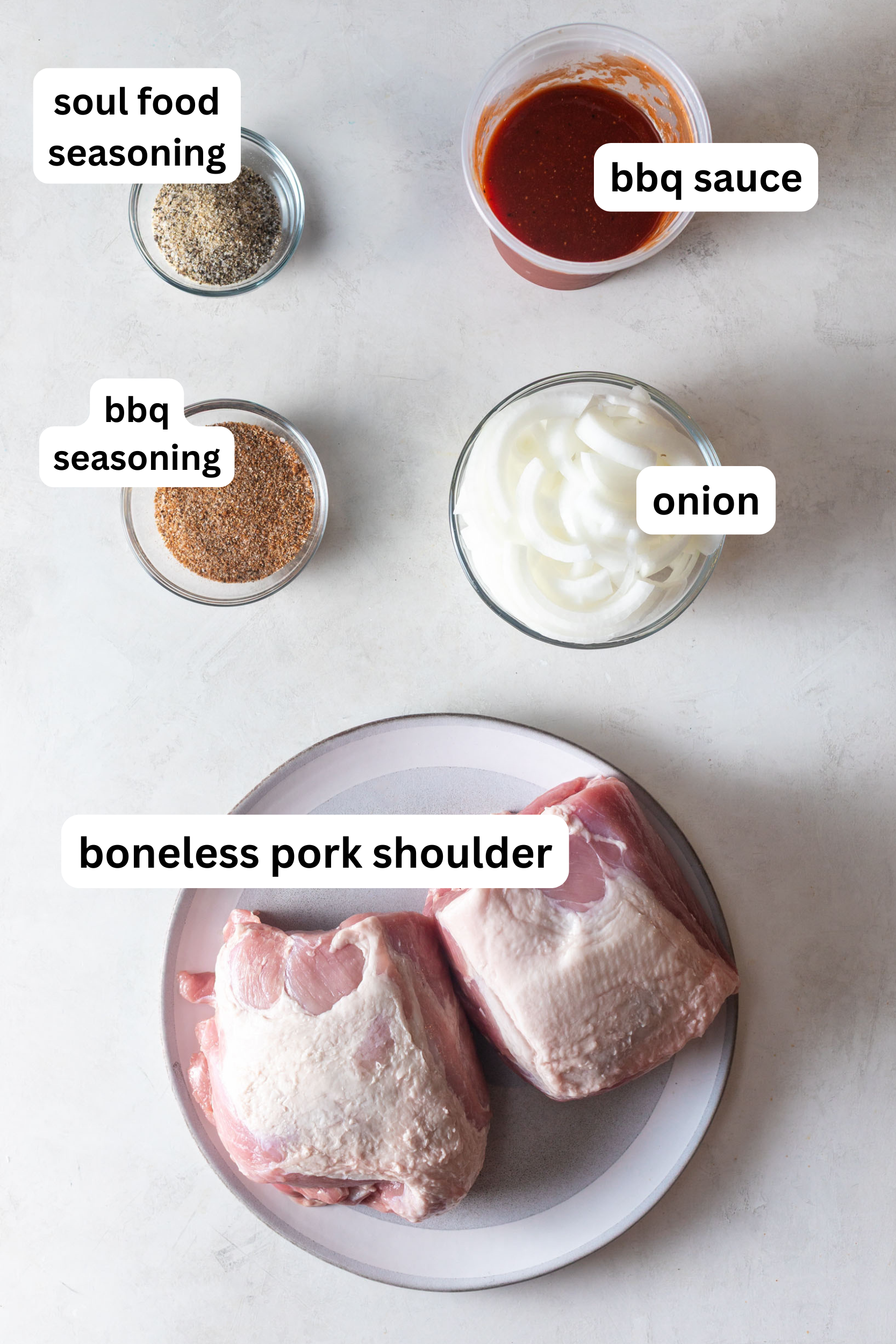BBQ pulled pork slow cooker ingredients (bbq sauce, onion, boneless pork shoulder, bbq seasoning, soul food seasoning)