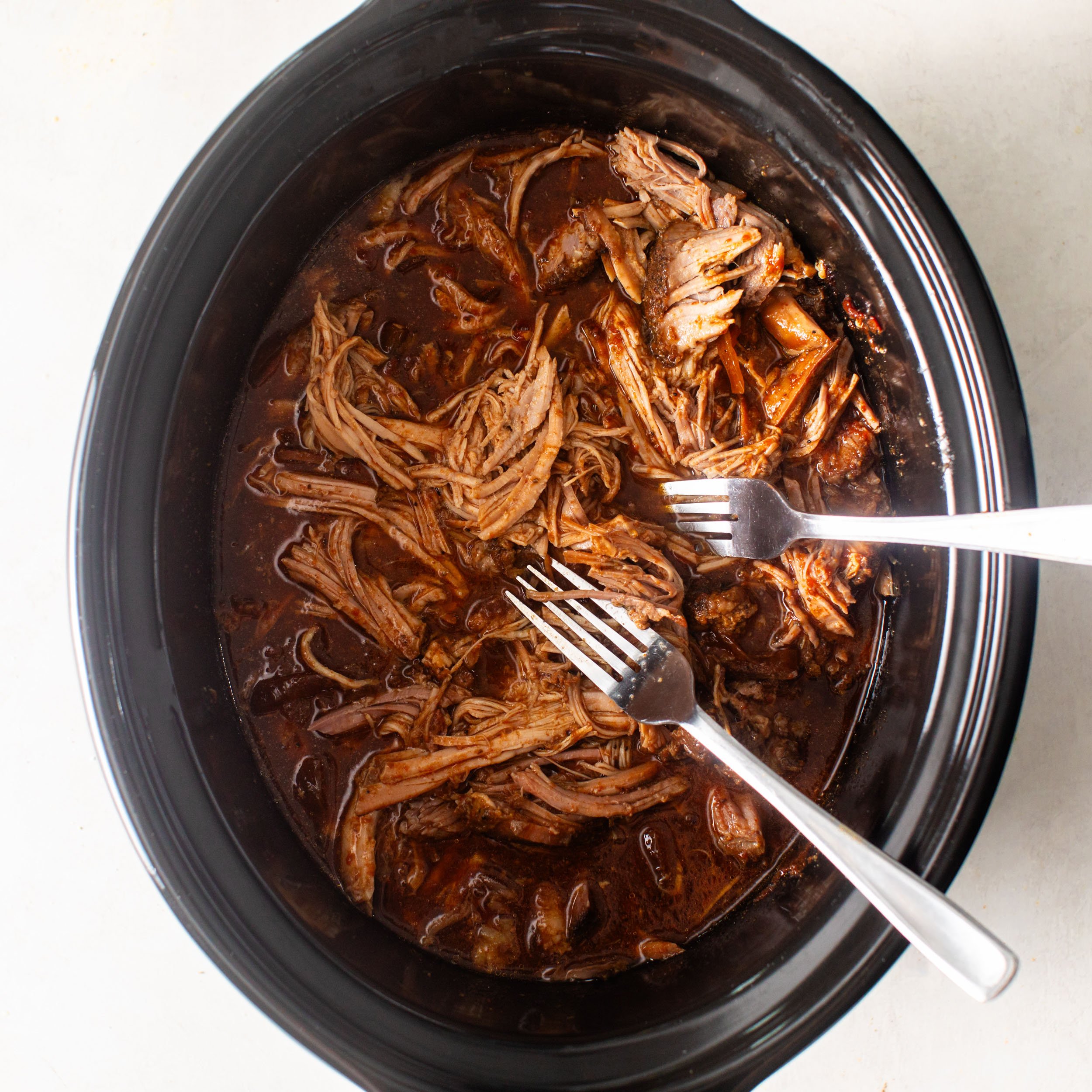 shredded BBQ pulled pork in a slow cooker 